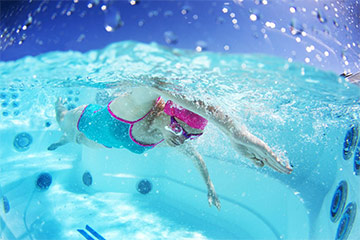 Swimming against a jetted Swimcross Exercise System